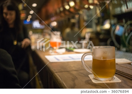 Frosty glass of light beer on the bar counter Frosty glass of light beer on the bar counter 36076894