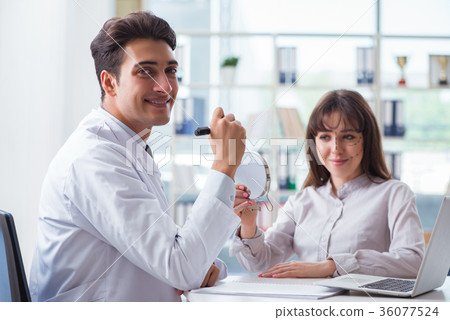 Plastic surgeon preparing for operation on woman 36077524