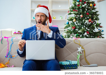Businessman working at home during christmas Businessman working at home during christmas 36078001