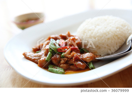 fried pork with thai curry and rice on wood background , Thai food fried pork with thai curry and rice on wood background , Thai food 36079999