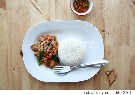 fried pork with thai curry and rice on wood background , Thai food fried pork with thai curry and rice on wood background , Thai food 36080701