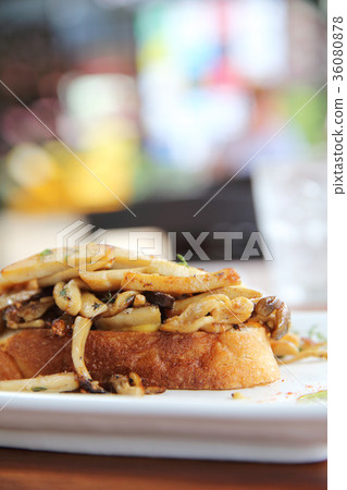 Crispy toasted white bread with mushrooms on wood background table 36080878