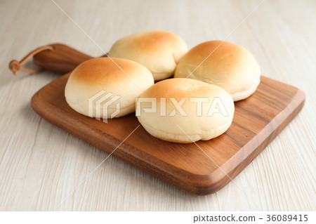 Freshly baked white bread placed on a wooden cutting board 36089415