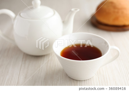 Tea teapot teacups on a table 36089416