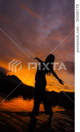 Silhouette of woman with sunset light background. Silhouette of woman with sunset light background. 36090779