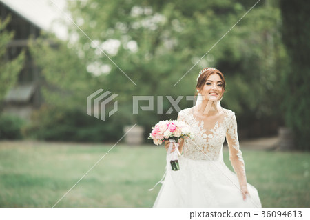 Beautiful bride in elegant white dress holding 36094613