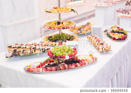 Delicious and tasty dessert table with cupcakes Delicious and tasty dessert table with cupcakes 36094936