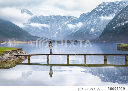 Woman on a deck over an alpine lake 36095029