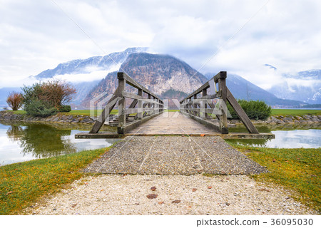 Wooden bridge leading to mountains Wooden bridge leading to mountains 36095030