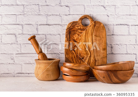 Wooden tableware on a white table. 36095335