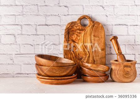 Wooden tableware on a white table. Wooden tableware on a white table. 36095336