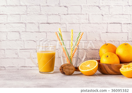 Oranges and juicer for making orange juice. 36095382