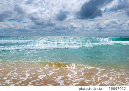 sandy beach of tropical ocean and  overcast sky. 36097012