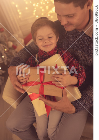 Father with son at home on Christmas evening Father with son at home on Christmas evening 36098616