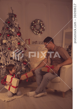 Father with son at home on Christmas evening 36098617