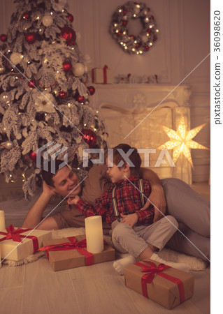Father with son at home on Christmas evening Father with son at home on Christmas evening 36098620