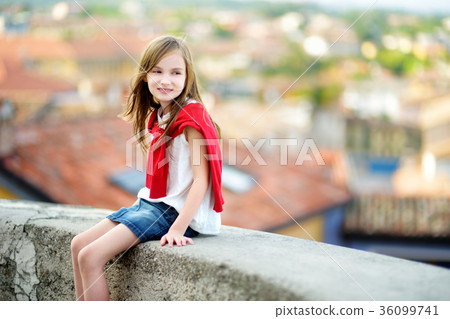 Adorable girl on warm and sunny summer day in Desenzano del Garda town in Italy 36099741