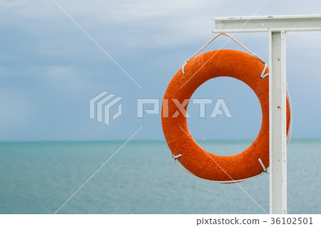 orange lifebuoy on the sea coast 36102501