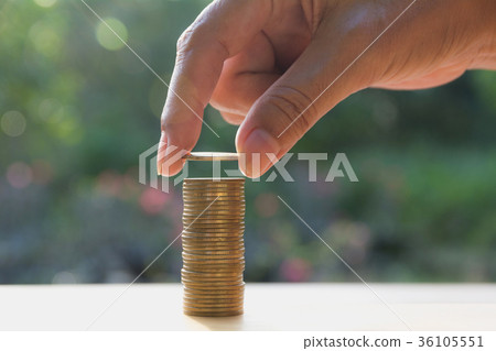 Saving money concept with hand holding coin 36105551