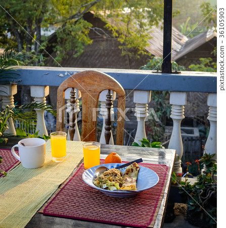 Breakfast with fried noodle, fruit juice on table Breakfast with fried noodle, fruit juice on table 36105903