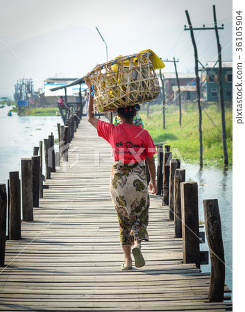 People walking on wooden bridge in Myanmar People walking on wooden bridge in Myanmar 36105904