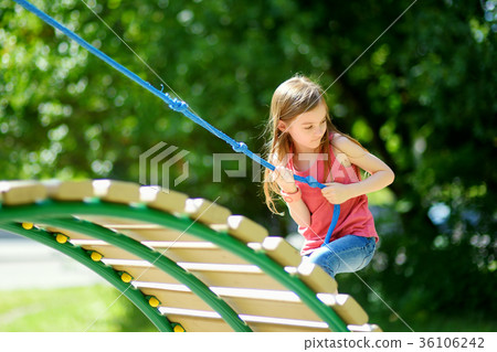 Cute little girl having fun on a playground outdoors Cute little girl having fun on a playground outdoors 36106242