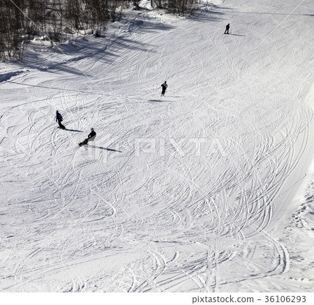 Skiers and snowboarders on ski slope at winter day Skiers and snowboarders on ski slope at winter day 36106293