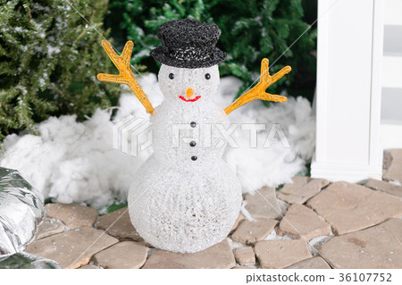 snowman in the foreground. house entrance 36107752