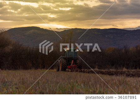 Tractor plowing fields Tractor plowing fields 36107891