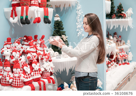 customer girl choosing gifts for Christmas and New 36108676
