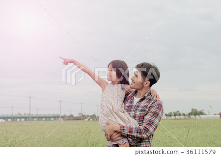 Father and daughter in happiness in the meadow Father and daughter in happiness in the meadow 36111579
