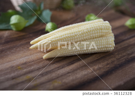 whole fresh baby corn on cutting board whole fresh baby corn on cutting board 36112328