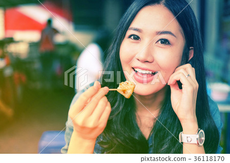 Woman eating Chinese steamed dumpling 36118170