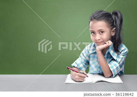 Smiling asian little girl doing her homework 36119642