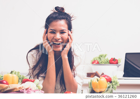 Woman with fruits and vegetables in the kitchen. Woman with fruits and vegetables in the kitchen. 36121260