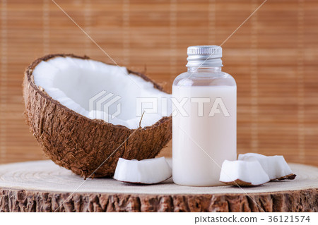 cosmetic bottle and fresh organic coconut for 36121574