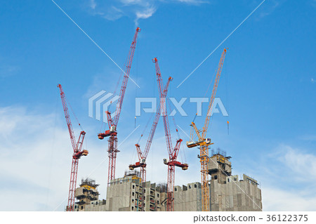 Tower cranes in building site on blue sky Tower cranes in building site on blue sky 36122375