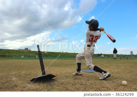Baseball boy practicing batting under blue sky Baseball boy practicing batting under blue sky 36124299