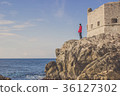 A man standing at Adriatic sea on fort, Dubrovnik. 36127302
