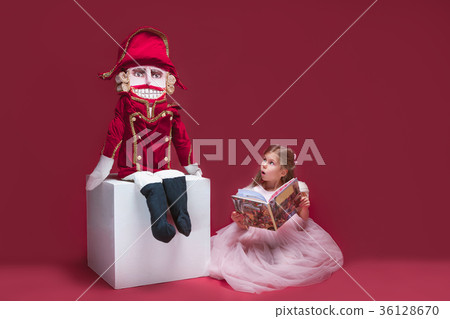 The beauty ballerina sitting with nutcracker The beauty ballerina sitting with nutcracker 36128670