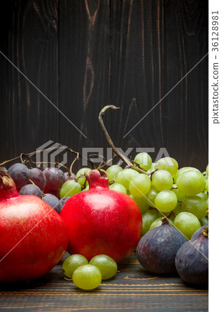 Lots of different fruits on wooden background 36128981