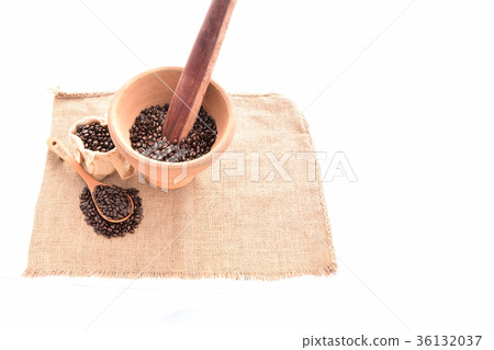 coffee beans with the mortar and flail on the sack 36132037