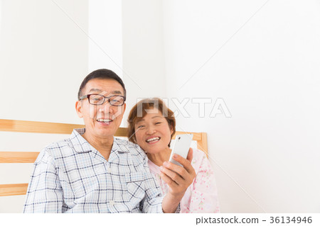 Senior couple smartphone bed Senior couple smartphone bed 36134946