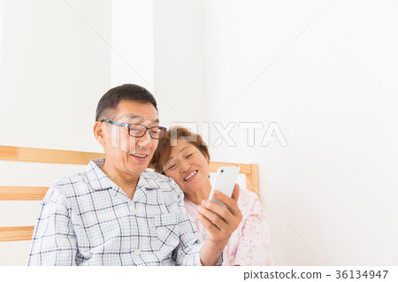 Senior couple smartphone bed Senior couple smartphone bed 36134947