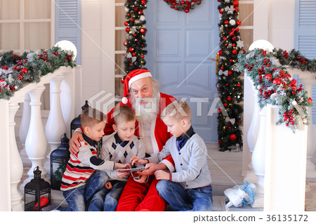 Happy children playing with Santa Claus. 36135172