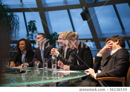 A group of business people sitting at a table A group of business people sitting at a table 36136539