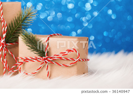 Christmas kraft gift on blue background Christmas kraft gift on blue background 36140947