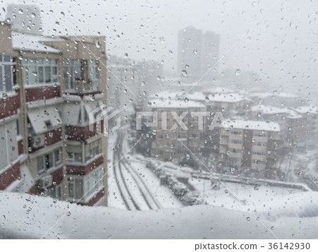 drops on window against city view under snow drops on window against city view under snow 36142930