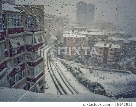 drops on window against city view under snow drops on window against city view under snow 36142931
