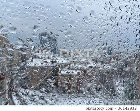 drops on window against city view under snow drops on window against city view under snow 36142932